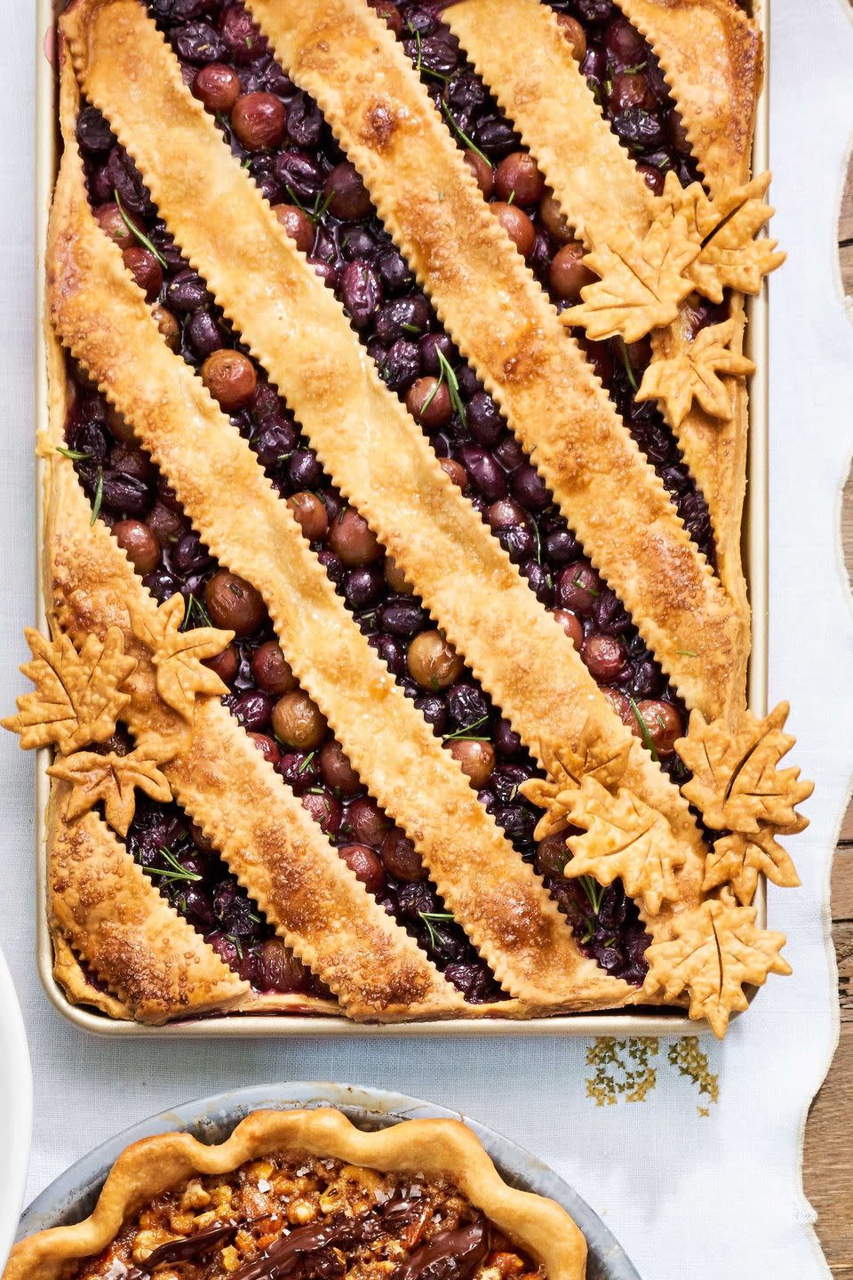 grape slab pie in a gold rectangle pan with lattice crust on top