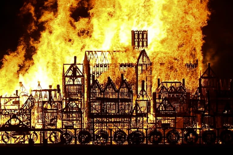 A replica of 17th-century London on a barge floating on the river Thames burns in an event to mark the 350th anniversary of the Great Fire of London