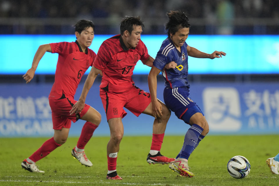 Japan's Daiki Matsuoka, right, battles for the ball against South Korea's Song Minkyu, center, and Hyong Hyunseok during their men's soccer gold medal match at the 19th Asian Games in Hangzhou, China, Saturday, Oct. 7, 2023. (AP Photo/Aijaz Rahi)