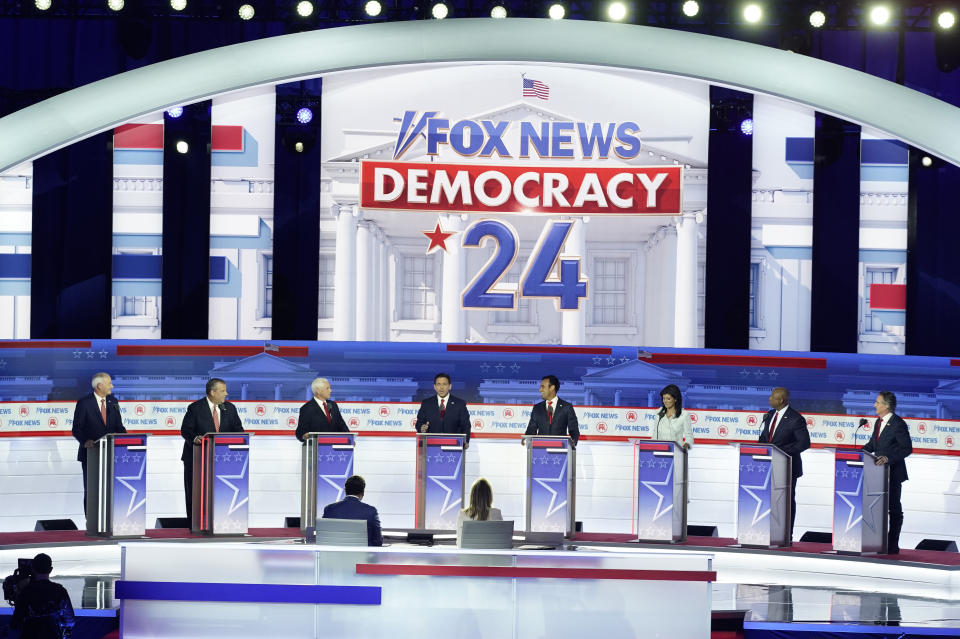 FILE - Republican presidential candidates, from left, former Arkansas Gov. Asa Hutchinson, former New Jersey Gov. Chris Christie, former Vice President Mike Pence, Florida Gov. Ron DeSantis, businessman Vivek Ramaswamy, former U.N. Ambassador Nikki Haley, Sen. Tim Scott, R-S.C., and North Dakota Gov. Doug Burgum stand at their podiums during a Republican presidential primary debate hosted by FOX News Channel Wednesday, Aug. 23, 2023, in Milwaukee. (AP Photo/Morry Gash, File)