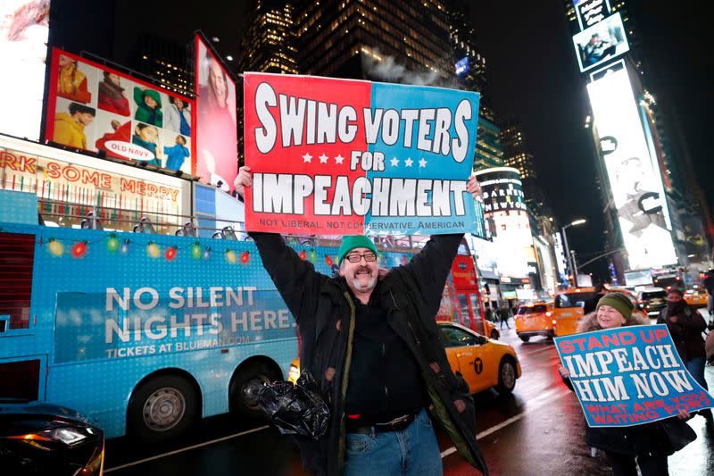 Demonstrators gather to demand the impeachment and removal of U.S. President Donald Trump during a rally at Times Square in New York City