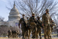 Members of the National Guard patrol outside the Capitol Building on Capitol Hill in Washington, Thursday, Jan. 14, 2021. (AP Photo/Andrew Harnik)