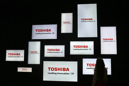 A visitor looks at a display of Japan's Toshiba company during the IFA Electronics show in Berlin, Germany in this September 4, 2014 file photo. REUTERS/Hannibal Hanschke/Files