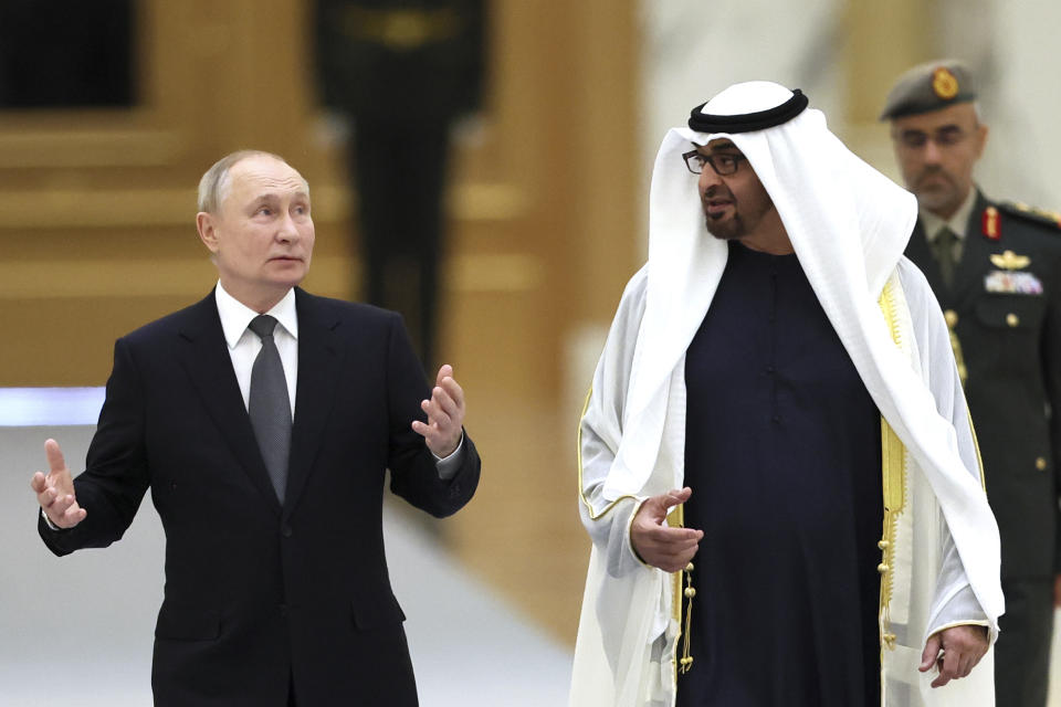 Russian President Vladimir Putin, left, gestures speaking to Emirati President Sheikh Mohammed bin Zayed Al Nahyan during an official welcome ceremony at Qasr Al Watan, Abu Dhabi, United Arab Emirates, Wednesday, Dec. 6, 2023. (Sergei Savostyanov, Sputnik, Kremlin Pool Photo via AP)