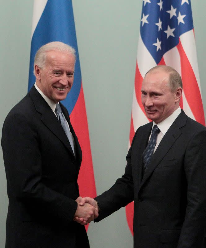 FILE PHOTO: Russian Prime Minister Putin shakes hands with U.S. Vice President Biden during their meeting in Moscow