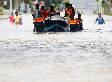 A Sri Lanka navy rescue team use a boat on a flooded road in Kaduwela, Sri Lanka May 20, 2016. REUTERS/Dinuka Liyanawatte