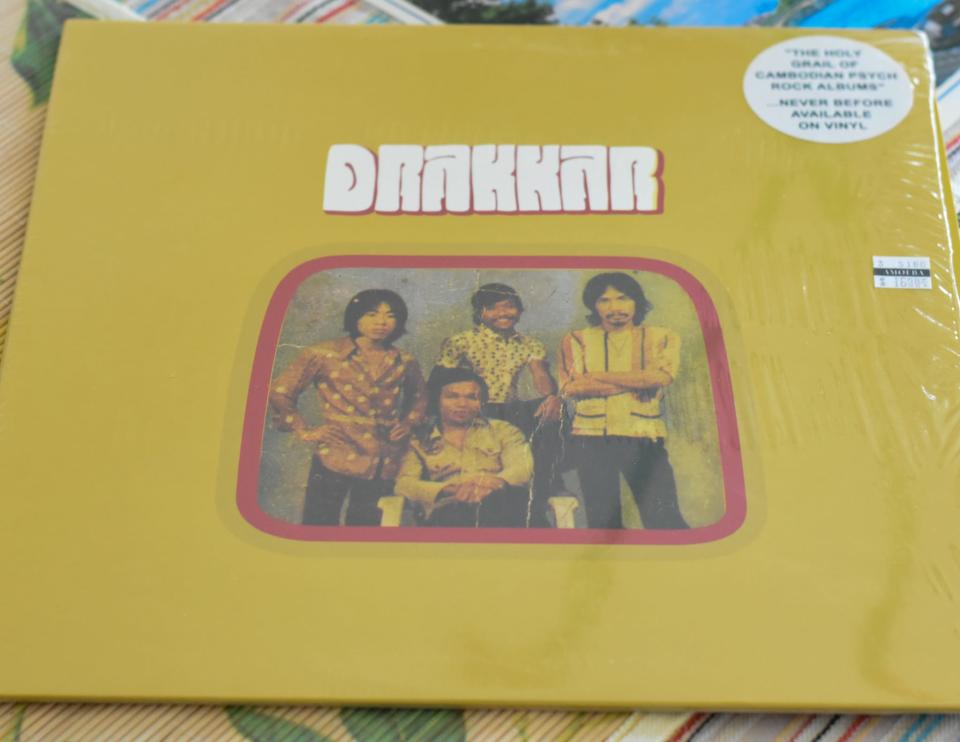 A vinyl release of the Cambodian rock band Drakkar's 1974 album. The Khmer Rogue destroyed many recordings and copies of the vibrant Cambodian rock genre, but have found new life from found copies and digital transfers. A recording of Drakkar's lost album was discovered during the 2000s and released in 2014.