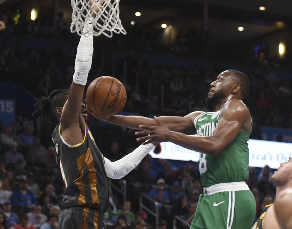 Boston Celtics guard Kemba Walker (8) shoots around Oklahoma City Thunder forward Nerlens Noel (9) in the second half of an NBA basketball game, Sunday, Feb. 9, 2020, in Oklahoma City. (AP Photo/Kyle Phillips)