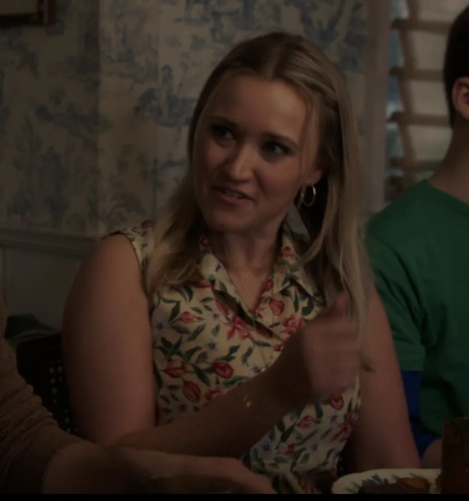 Mandy in a floral blouse at the dinner table