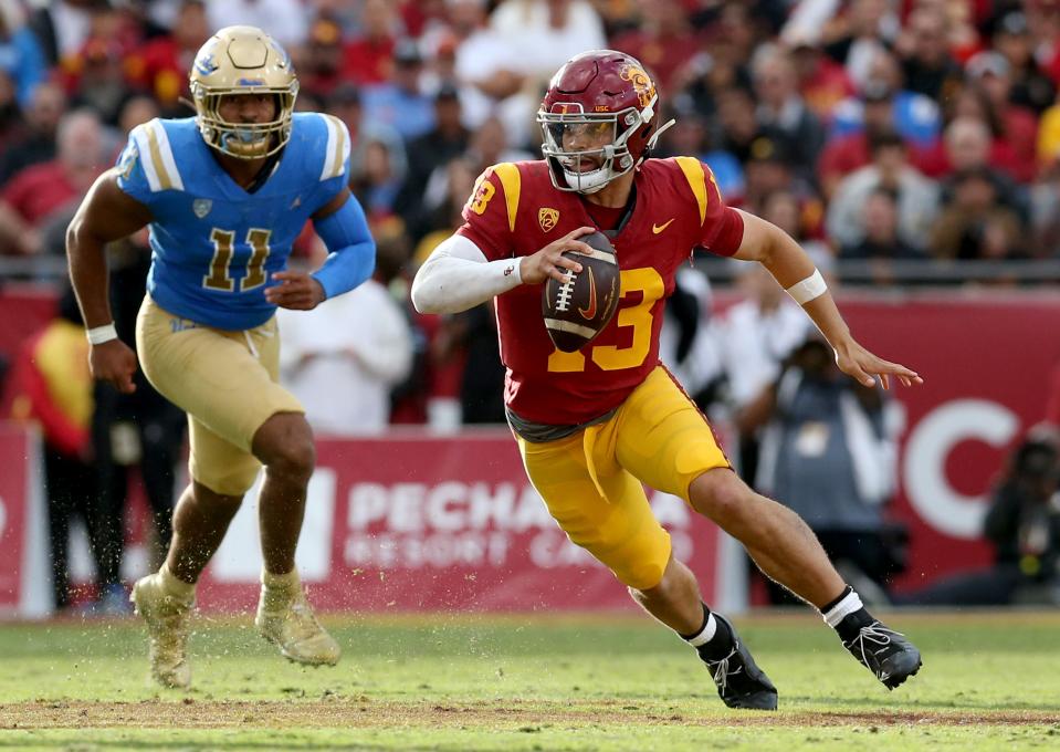 USC quarterback Caleb Williams scrambles during the third quarter against UCLA at United Airlines Field at Los Angeles Memorial Coliseum, Nov. 18, 2023 in Los Angeles.