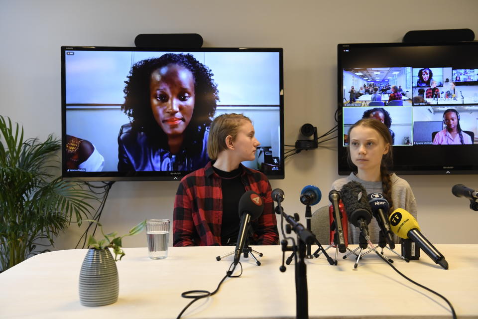 Climate activist Vanessa Nakate, left, speaks via video-link as Ell Ottosson Jarl and Greta Thunberg, right, also attend a press conference with climate activists and experts from Africa in Stockholm, Sweden, Friday Jan. 31, 2020. Ugandan climate activist Vanessa Nakate and peers from other African nations on Friday made an urgent appeal for the world to pay more attention to the continent that stands to suffer the most from global warming despite contributing to it the least. (Pontus Lundahl/TT via AP)
