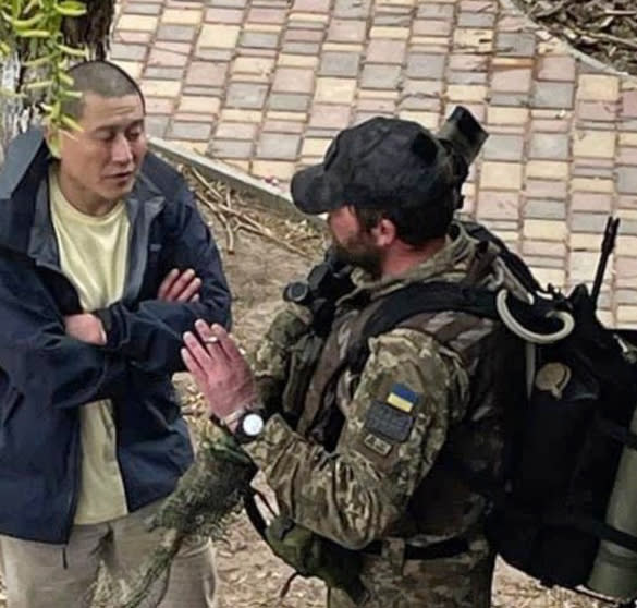 Grady Kurpasi speaks to a Ukrainian soldier in Kyiv in early April. He would go missing outside Kherson later that month. (Courtesy George Heath)