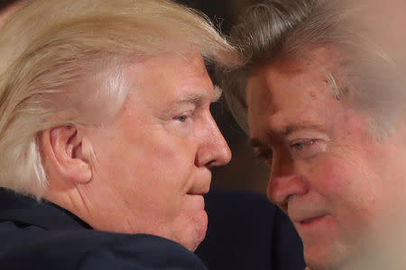 FILE PHOTO: U.S. President Donald Trump talks to chief strategist Steve Bannon during a swearing in ceremony for senior staff at the White House in Washington, U.S. January 22, 2017. REUTERS/Carlos Barria/FILE PHOTO