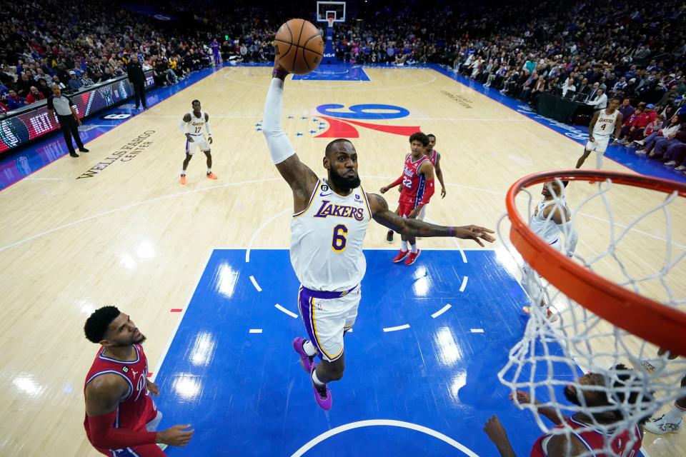 FILE - Los Angeles Lakers' LeBron James goes up for a dunk during the first half of an NBA basketball game against the Philadelphia 76ers, Friday, Dec. 9, 2022, in Philadelphia. Lakers coach Darvin Ham, in an essay for The Associated Press, says James' work ethic is beyond compare. James is about to pass Kareem Abdul-Jabbar for the NBA career scoring record. (AP Photo/Matt Slocum, File)