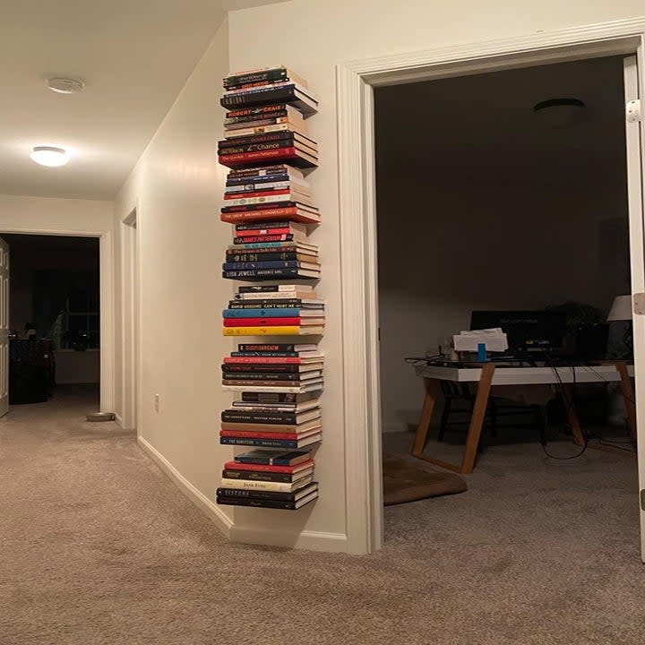 reviewer photo showing a stack of floating book shelves filled with several books 