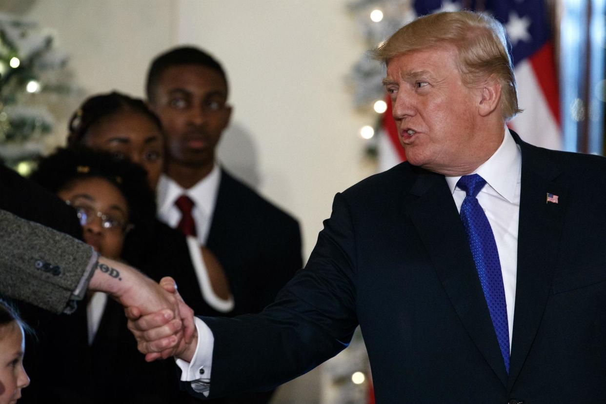 President Donald Trump shakes hands after speaking on tax reform in the Grand Foyer of the White House, Wednesday, Dec. 13, 2017, in Washington. (AP Photo/Evan Vucci)