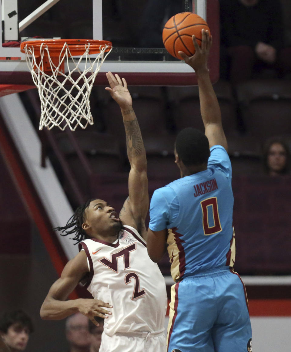 Florida State's Chandler Jackson (0) is defended by Virginia Tech's MJ Collins (2) in the first half of an NCAA college basketball game Tuesday, Feb. 13, 2024, in Blacksburg, Va. (Matt Gentry/The Roanoke Times via AP)