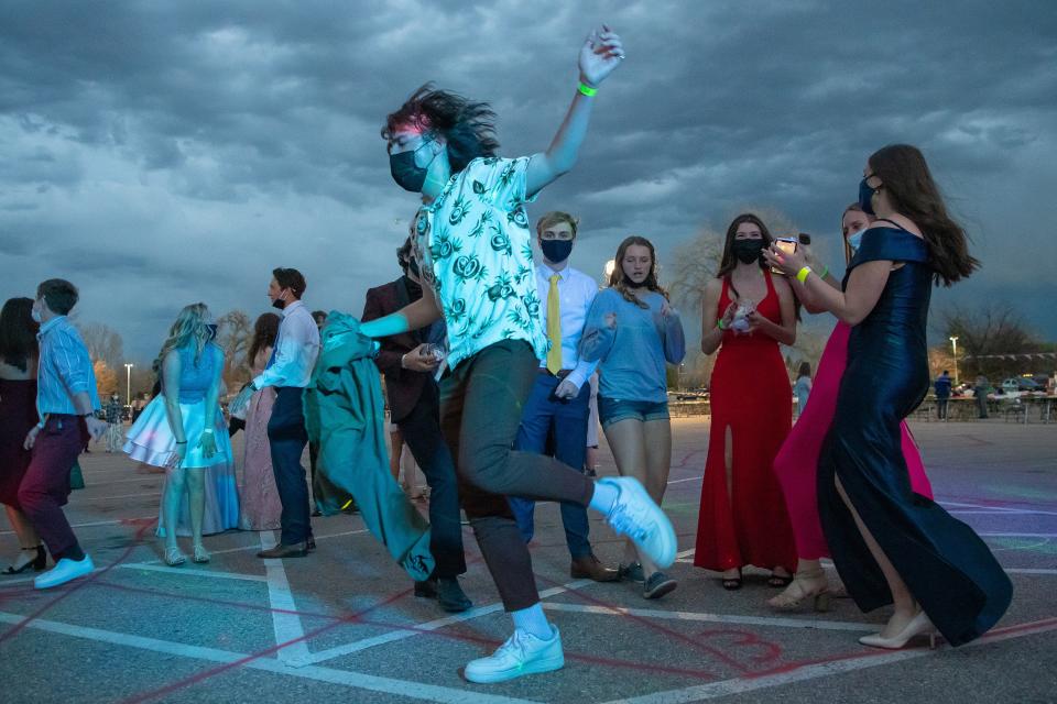 Zul Gorecki, 18, dances in a Rocky Mountain High School parking lot during the school's prom on Saturday, May 1, 2021, in Fort Collins, Colo. The prom was held outside because of COVID-19 safety concerns.