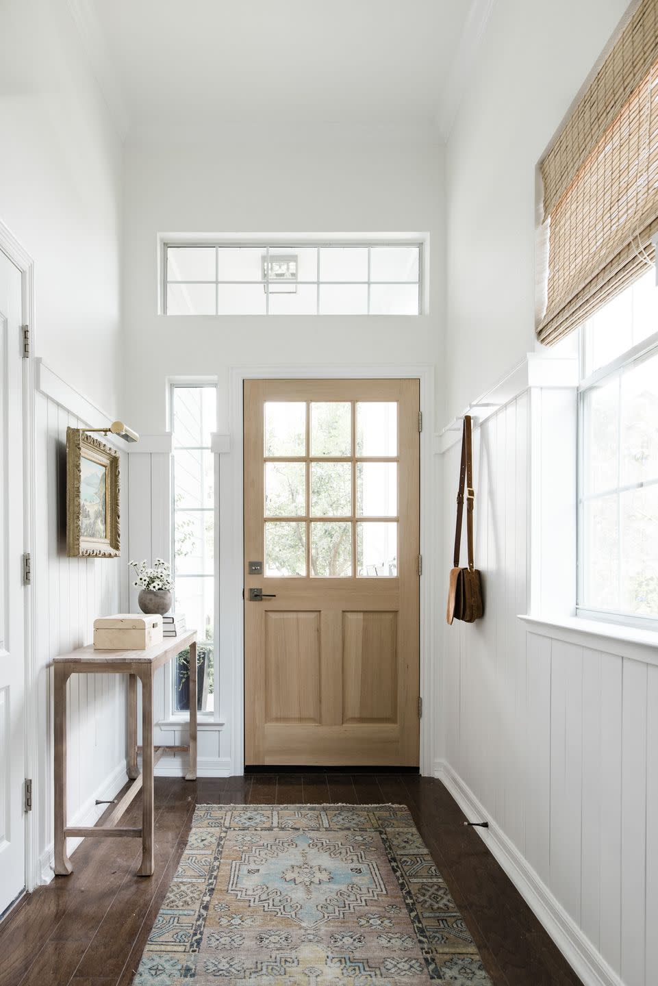 simple wooden table and hooks in entryway