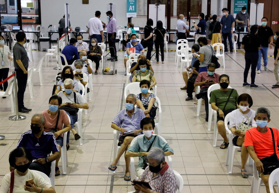 People above 70 years old wait in an observation area after getting a dose of the coronavirus disease vaccine at a vaccination centre in Singapore on 27 January, 2021. (PHOTO: Reuters)