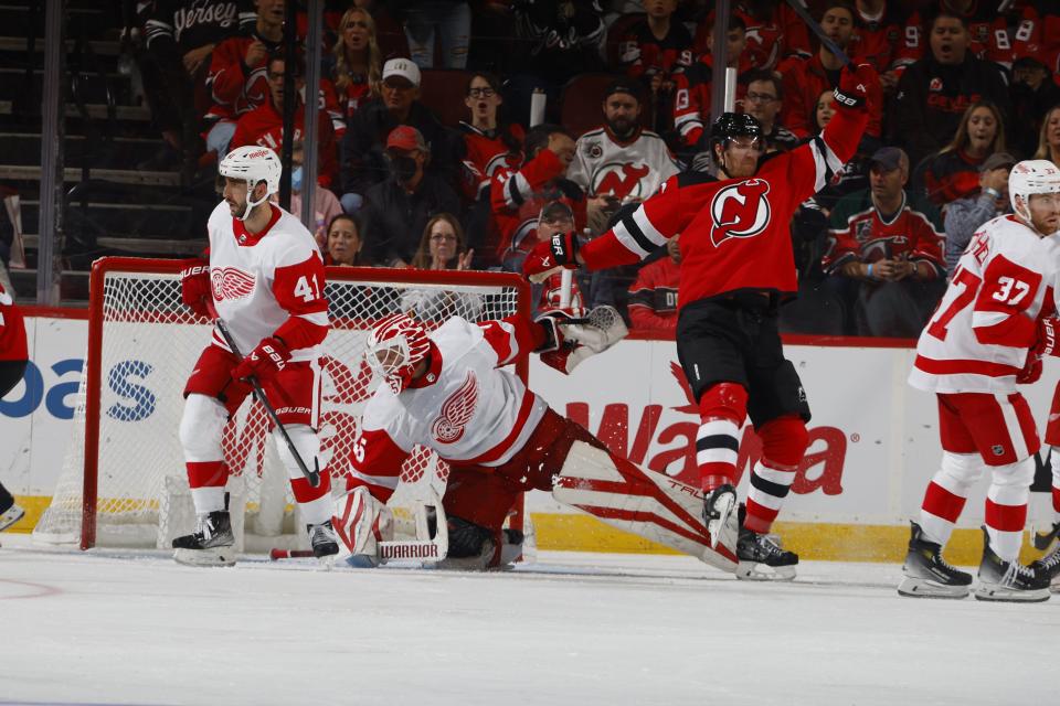 Alex DeBrincat (93) of the Detroit Red Wings scores a powerplay goal at 10:43 of the third period against Vitek Vanecek of the New Jersey Devils at Prudential Center in Newark, New Jersey, on Thursday, Oct. 12, 2023.