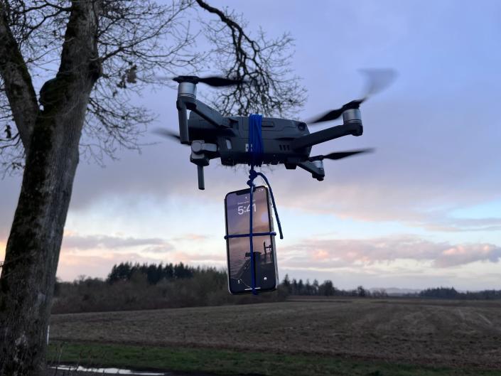 A reenactment of a phone attached to a drone that could potentially be flown to reach cell phone service.