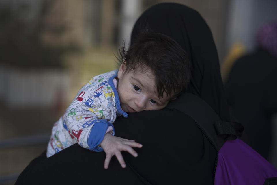 One month Sonia Al Taie who lives with 6 family members in Malakasa refugee camp, on the outskirt of Athens takes part in a protest against the living conditions at the camp, outside the Ministry of Migration in Nikea, suburb of Athens, Monday, Oct. 8, 2018. (AP Photo/Petros Giannakouris)