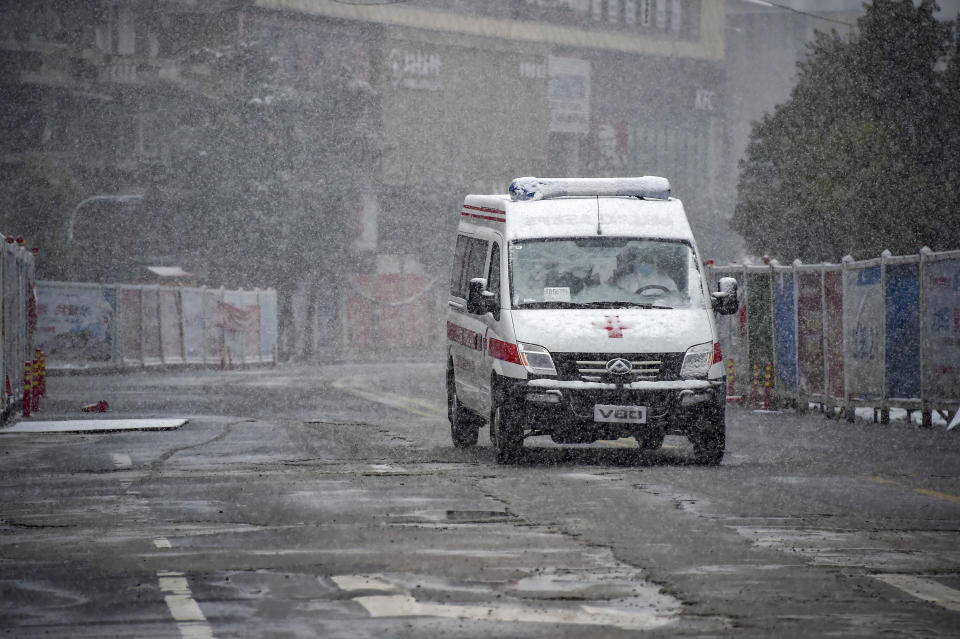 In this photo released by China's Xinhua News Agency, an ambulance drives along a road during a snowfall in Xiaogan in central China's Hubei Province, Saturday, Feb. 15, 2020. The virus is thought to have infected more than 67,000 people globally and has killed at least 1,526 people, the vast majority in China, as the Chinese government announced new anti-disease measures while businesses reopen following sweeping controls that have idled much of the economy. (Hu Huhu/Xinhua via AP)