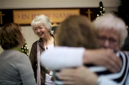 Members of the congregation at New Covenant Community Church greet Terri Roberts, the mother of Amish school shooter Charles Roberts, in Delta, Pennsylvania December 1, 2013. REUTERS/Mark Makela