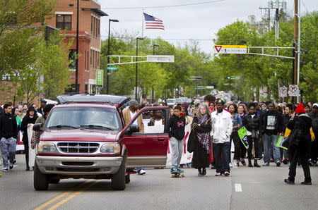 People march after a prosecutor said that a police officer will not face charges in the fatal shooting of an unarmed 19-year-old biracial man, in Madison, Wisconsin May 12, 2015. REUTERS/Ben Brewer