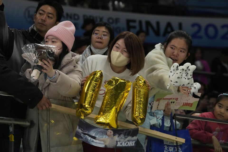Fans of gold medalist Japan's Kaori Sakamoto react to her after her Free Skating routine in the Women's Final for the ISU Grand Prix of Figure Skating Final held in Beijing, Saturday, Dec. 9, 2023. (AP Photo/Ng Han Guan)