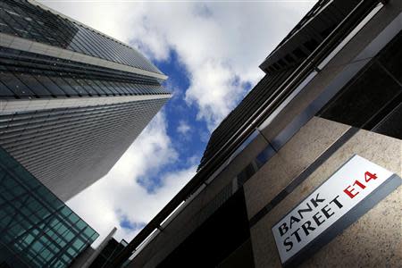 A sign for Bank Street and high rise offices are pictured in the financial district Canary Wharf in London in this October 21, 2010 file photo. REUTERS/Luke Macgregor/Files