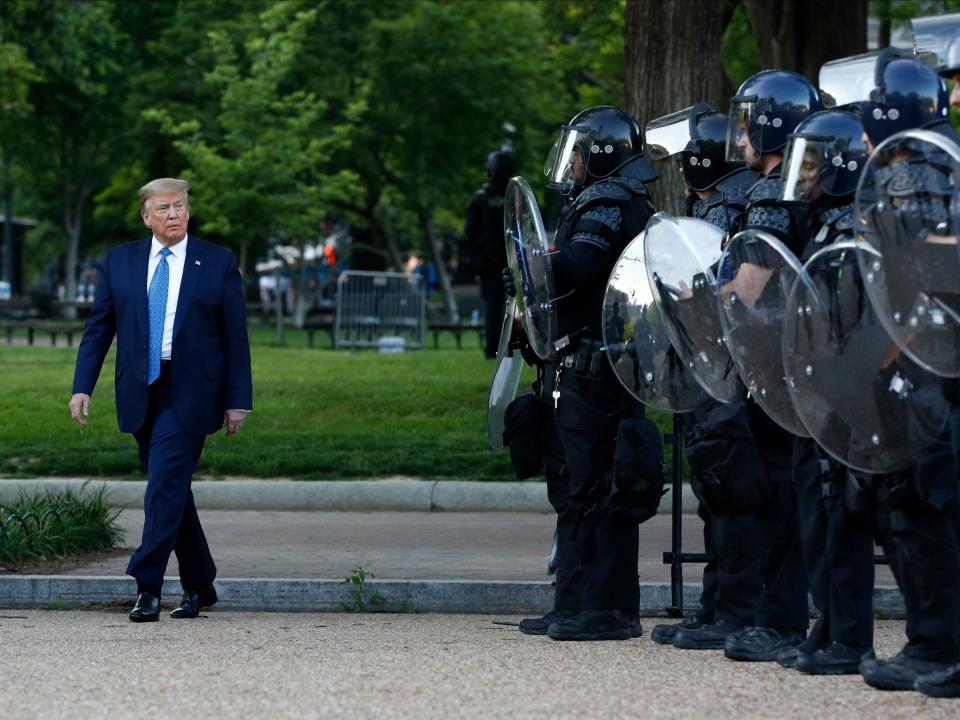 President Donald Trump walks past police in Lafayette Park after visiting outside St. John's Church across from the White House Monday, June 1, 2020, in Washington. Part of the church was set on fire during protests on Sunday night. (AP Photo/Patrick Semansky)