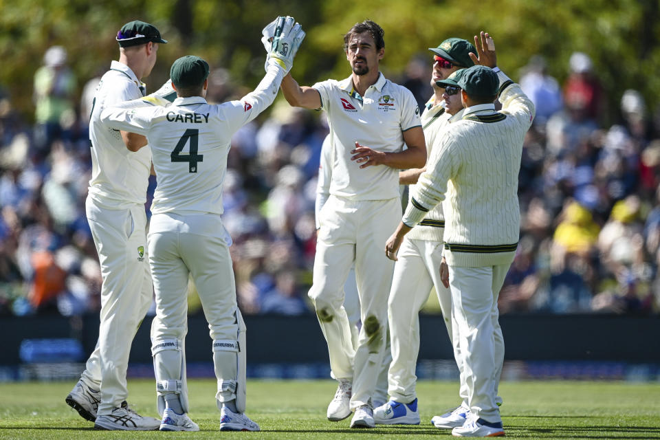 Mitchell Starc, centre, of Australia celebrates with teammates after taking the wicket of New Zealand's Glenn Phillips on day one for the second cricket test between New Zealand and Australia in Christchurch, New Zealand, Friday March 8, 2024. (John Davidson/Photosport via AP)