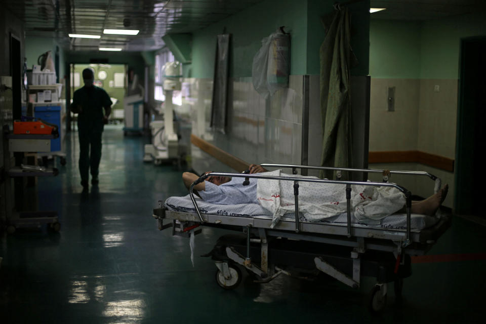 A patient lies on a bed before surgery