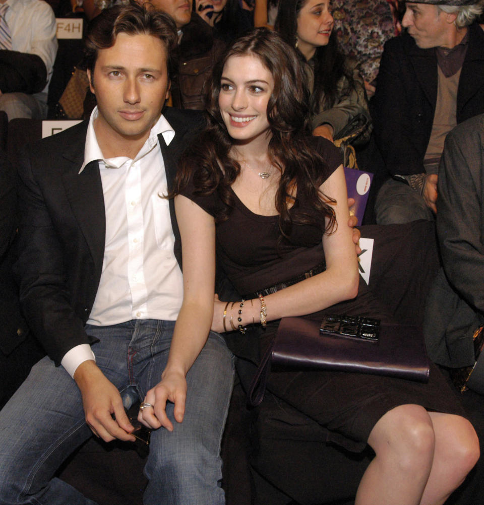 FILE - In this Feb. 3, 2008, file photo, actress Anne Hathaway, right, sits with her boyfriend, Raffaello Follieri, at the Miss Sixty fashion show during fashion week in New York. Follieri was released Friday morning from a prison in Loretto, 80 miles east of Pittsburgh. Follieri pleaded guilty to cheating investors by falsely claiming he had Vatican connections that enabled him to buy church property at a discount. He was sentenced in 2008 to 4 1/2 years in prison. Follieri agrees he owes more than $3.6 million to those he ripped off. The proceeds supported a playboy lifestyle that included a $37,000-a-month New York City apartment and lavish vacations with Hathaway, the star of "The Princess Diaries." (AP Photo/Brian McDermott)