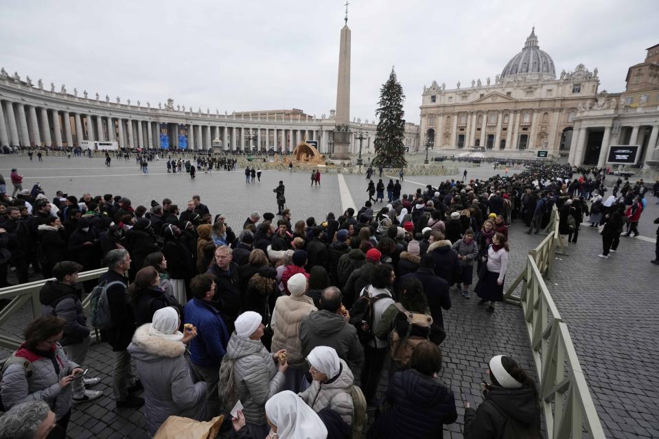 People wait in a line to enter Saint Peter's Basilica at the Vatican where late Pope Benedict 16 is being laid in state at The Vatican, Monday, Jan. 2, 2023. Benedict XVI, the German theologian who will be remembered as the first pope in 600 years to resign, has died, the Vatican announced Saturday. He was 95. (AP Photo/Alessandra Tarantino)