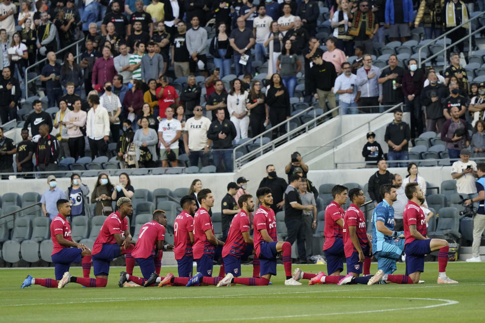 Dallas FC players take a kneed during the national anthem before of an MLS soccer match against Los Angeles FC Wednesday, June 23, 2021, in Los Angeles. (AP Photo/Marcio Jose Sanchez)