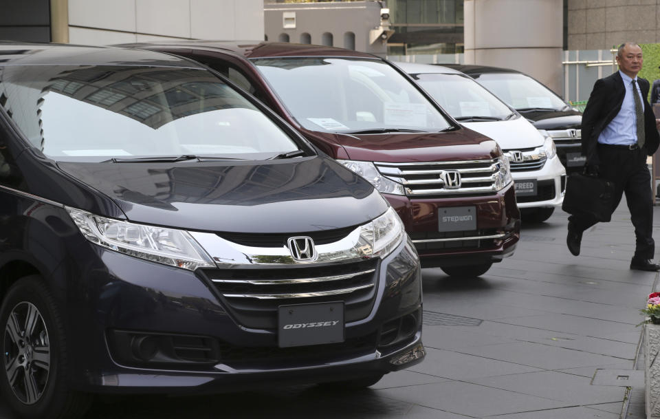 A man walks past Honda models on display at Honda Motor Co. headquarters in Tokyo, Friday, April 25, 2014. Honda's profit for the fiscal fourth quarter zoomed to more than double the previous year's as the benefits of a weak yen added to strong sales. (AP Photo/Koji Sasahara)