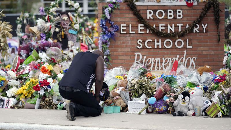 Reggie Daniels pays his respects at a memorial at Robb Elementary School, June 9, 2022, in Uvalde, Texas. The memorial was created to honor the victims killed in the mass shooting at the school. Since the massacre, state legislators passed more laws expanding gun access than gun control measures.