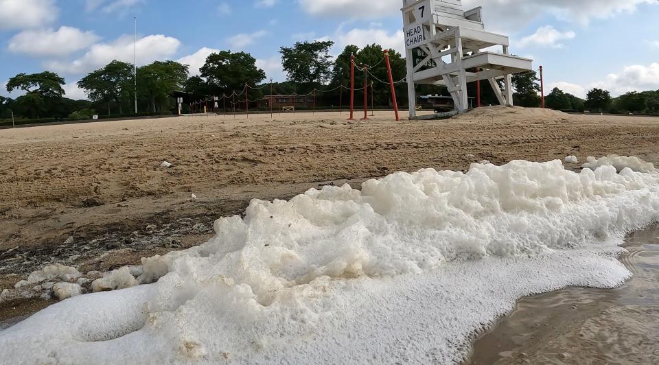 Algae bloom foam gathers on the shoreline of Lake Welch in Harriman State Park Aug. 30, 2022. The lake has be closed because of a harmful algal bloom.