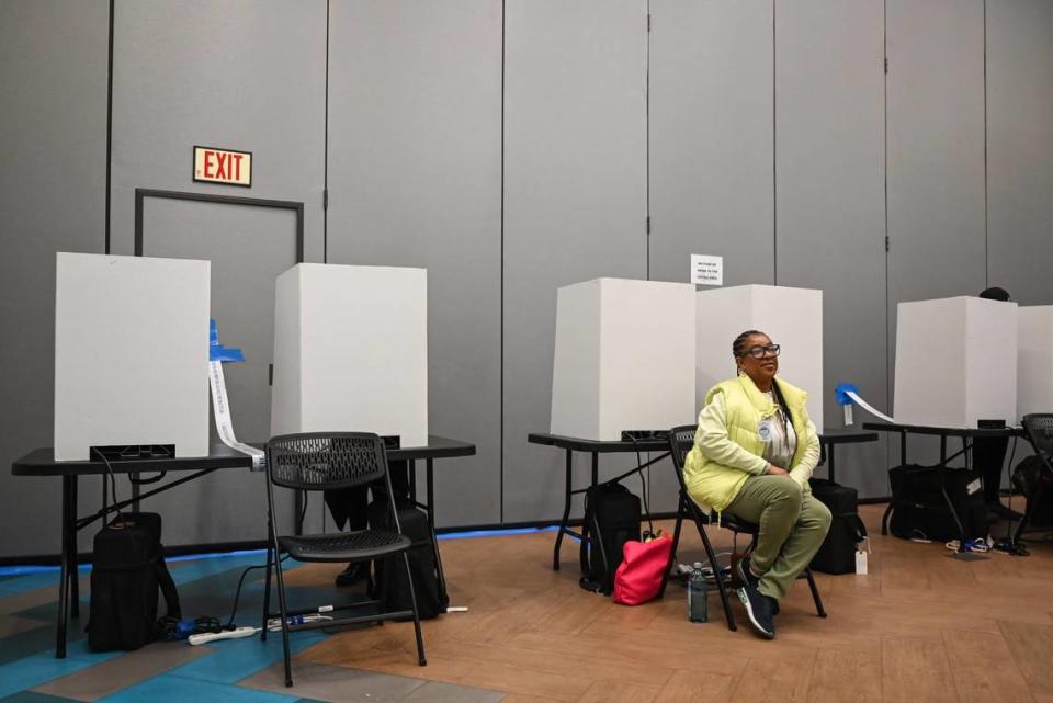 Election official Shawn Beans smiles as she monitors the voting area at Eastway Regional Recreation Center in Charlotte, NC on February 28, 2024.