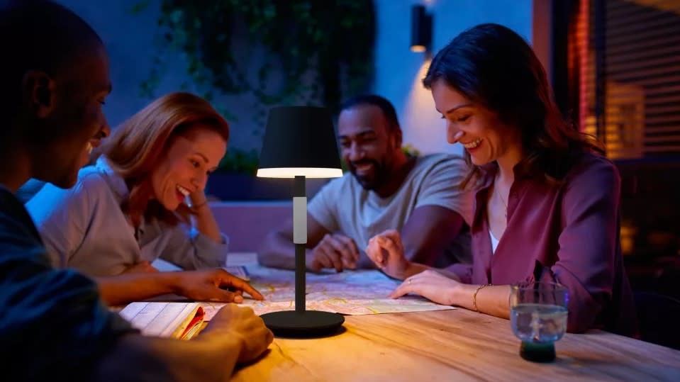 A Hue Go portable table lamp being used outside