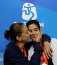 Silver medallist for the men's -68kg taekwondo competition Mark Lopez (R) of the U.S. and bronze medallist for the women's -57kg taekwondo competition Diana Lopez of the U.S. pose at the Beijing 2008 Olympic Games, August 21, 2008. REUTERS/Alessandro Bianchi/File Photo