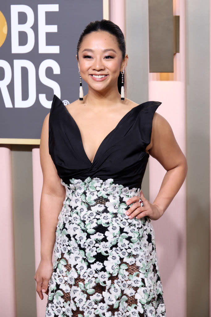 Stephanie smiling in a sleeveless floral-print dress