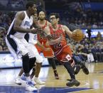 Chicago Bulls' Kirk Hinrich (12) drives around Orlando Magic's Andrew Nicholson, left, for a basket during the first half of an NBA basketball game in Orlando, Fla., Wednesday, Jan. 15, 2014. (AP Photo/John Raoux)