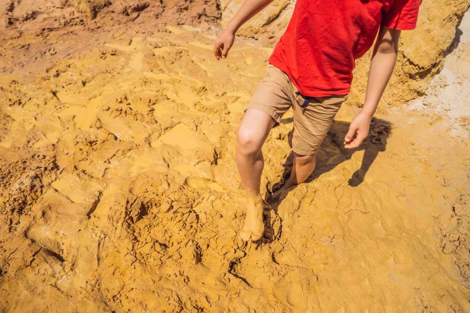 <p>Getty</p> A stock image of a man walking through quicksand.