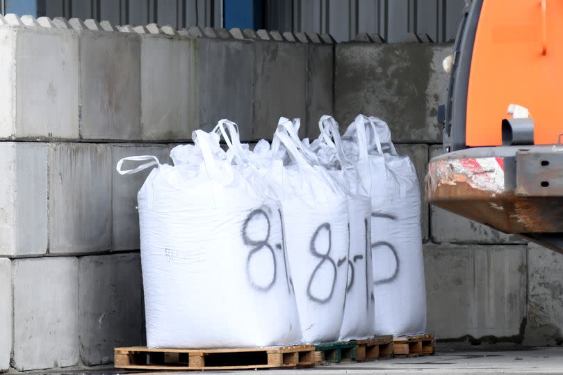 Cement and steel-related materials are loaded and unloaded at the wharf