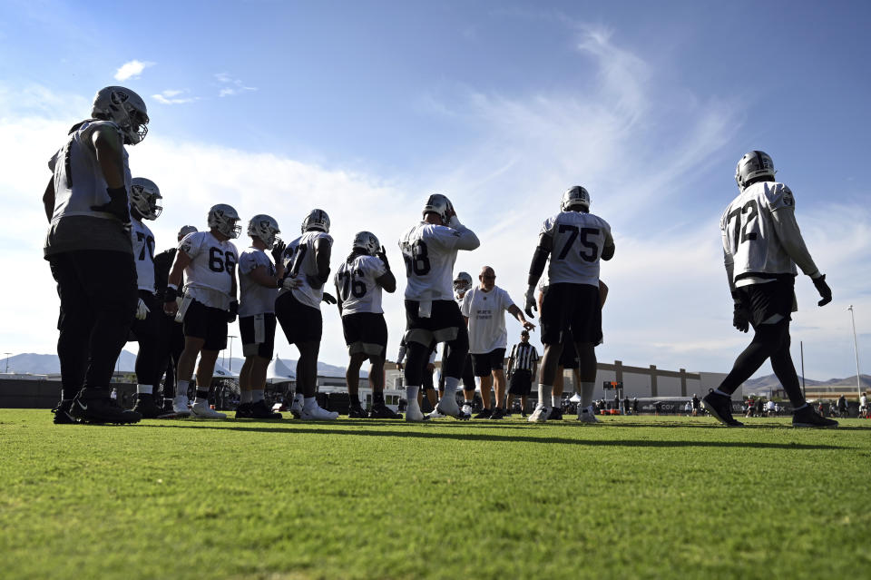 The Las Vegas Raiders offensive line runs drills during an NFL football practice Saturday, July 31, 2021, in Henderson, Nev. (AP Photo/David Becker)