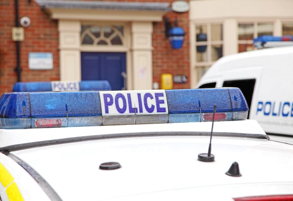 Close up of parked police vehicles outside a county police station.